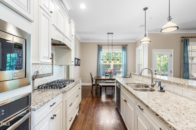2538 Tuffeto, Apex, NC 27502 - kitchen with stainless steel appliances, a sink, tasteful backsplash, dark wood-type flooring, and white cabinetry