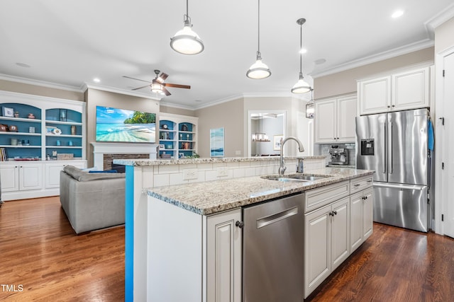2538 Tuffeto, Apex, NC 27502 - kitchen featuring stainless steel appliances, a sink, a ceiling fan, dark wood-style floors, and an island with sink