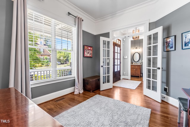 2538 Tuffeto, Apex, NC 27502 - foyer with french doors, ornamental molding, dark wood finished floors, and baseboards