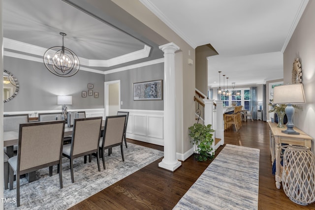3111 Virginia Pine Ln, Apex, NC 27539 - dining room featuring a chandelier, wood finished floors, ornate columns, ornamental molding, and stairway