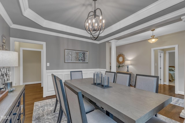 3111 Virginia Pine Ln, Apex, NC 27539 - dining room featuring decorative columns, dark wood-style flooring, a raised ceiling, crown molding, and a chandelier