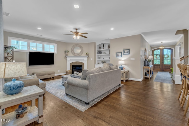 3111 Virginia Pine Ln, Apex, NC 27539 - living room featuring dark wood-type flooring, a ceiling fan, crown molding, recessed lighting, and a tile fireplace