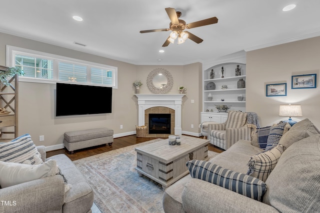 3111 Virginia Pine Ln, Apex, NC 27539 - living room with ceiling fan, wood finished floors, recessed lighting, a tile fireplace, and built in shelves