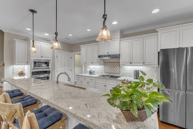 3111 Virginia Pine Ln, Apex, NC 27539 - kitchen featuring appliances with stainless steel finishes, under cabinet range hood, a breakfast bar, white cabinets, and recessed lighting