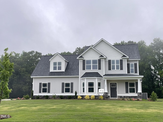 268 Busterfield Ct, Benson, NC 27504 - view of front facade featuring a front lawn, a shingled roof, covered porch, and central AC unit