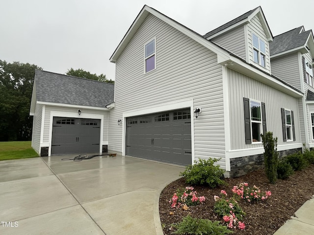 268 Busterfield Ct, Benson, NC 27504 - view of side of home with concrete driveway, an attached garage, and a shingled roof