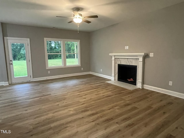 268 Busterfield Ct, Benson, NC 27504 - unfurnished living room featuring ceiling fan, a fireplace, baseboards, and wood finished floors