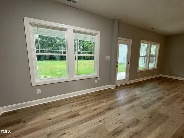 268 Busterfield Ct, Benson, NC 27504 - unfurnished living room featuring healthy amount of natural light, baseboards, and wood finished floors