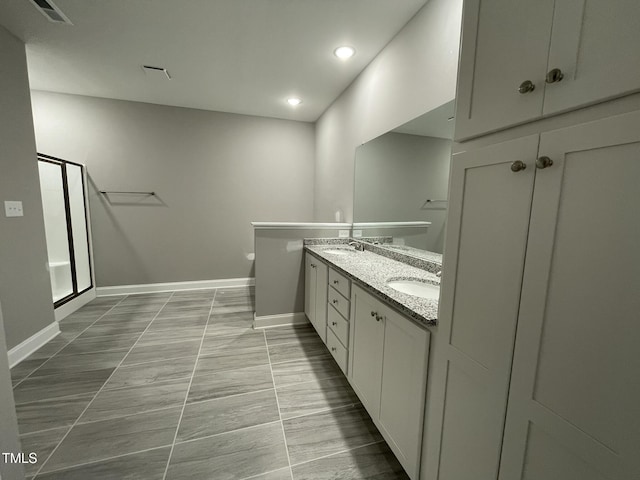 268 Busterfield Ct, Benson, NC 27504 - bathroom with double vanity, a shower stall, baseboards, and recessed lighting