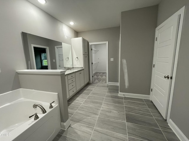 268 Busterfield Ct, Benson, NC 27504 - bathroom featuring vanity, a garden tub, baseboards, recessed lighting, and tile patterned floors