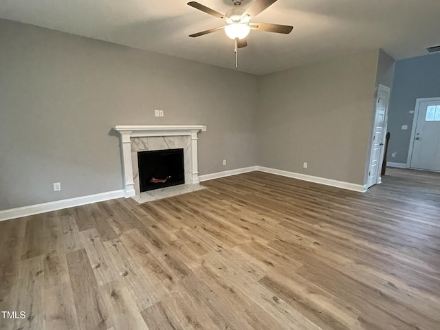 268 Busterfield Ct, Benson, NC 27504 - unfurnished living room featuring a ceiling fan, wood finished floors, baseboards, and a high end fireplace