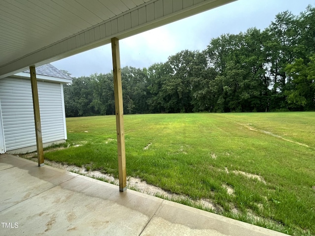 268 Busterfield Ct, Benson, NC 27504 - view of green lawn with a view of trees and a patio area