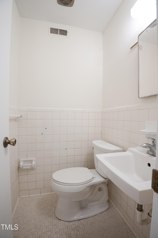 1002 Willow Dr Unit 37, Chapel Hill, NC 27514 - half bathroom with toilet, tile walls, tile patterned flooring, and a wainscoted wall