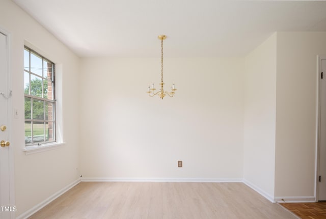 1002 Willow Dr Unit 37, Chapel Hill, NC 27514 - unfurnished dining area featuring a chandelier, light wood-style floors, and baseboards