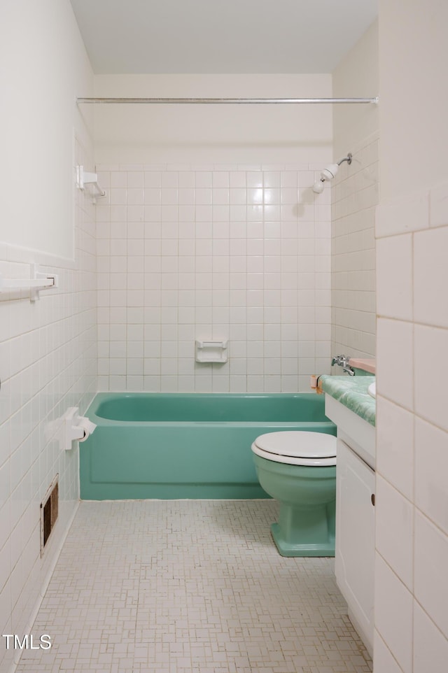 1002 Willow Dr Unit 37, Chapel Hill, NC 27514 - bathroom featuring tile walls, bathing tub / shower combination, vanity, toilet, and tile patterned floors