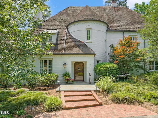 3307 Devon Rd, Durham, NC 27707 - view of front of house featuring a chimney and brick siding