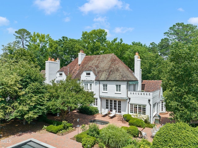 3307 Devon Rd, Durham, NC 27707 - rear view of house featuring a chimney, a patio, and french doors