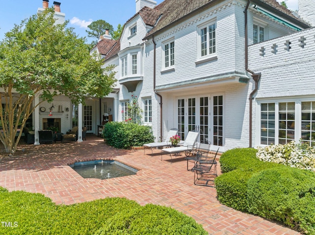 3307 Devon Rd, Durham, NC 27707 - back of house with french doors, a chimney, a patio area, brick siding, and an outdoor pool