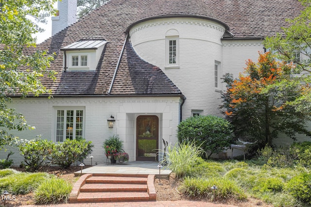 3307 Devon Rd, Durham, NC 27707 - view of front facade with a chimney and brick siding
