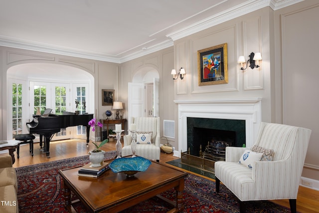 3307 Devon Rd, Durham, NC 27707 - living area with arched walkways, wood finished floors, crown molding, and a high end fireplace
