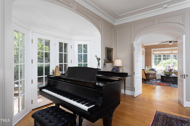 3307 Devon Rd, Durham, NC 27707 - living area with ornamental molding, arched walkways, light wood finished floors, ceiling fan, and a decorative wall
