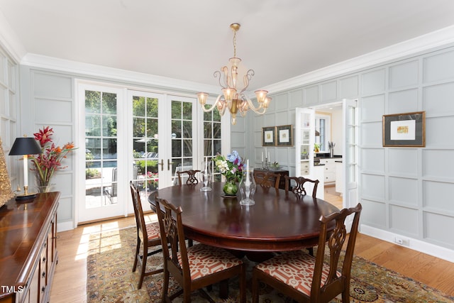 3307 Devon Rd, Durham, NC 27707 - dining space with a decorative wall, a chandelier, light wood finished floors, and ornamental molding