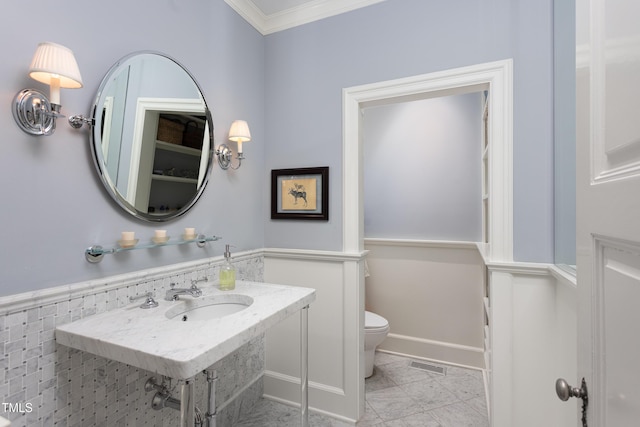 3307 Devon Rd, Durham, NC 27707 - bathroom featuring a sink, toilet, and ornamental molding