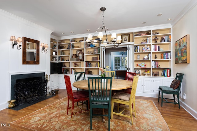 3307 Devon Rd, Durham, NC 27707 - dining area featuring a chandelier, ornamental molding, wood finished floors, a fireplace with flush hearth, and built in features