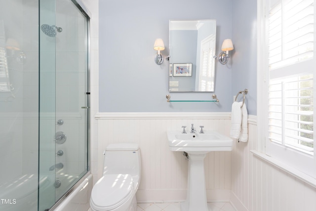 3307 Devon Rd, Durham, NC 27707 - full bath with toilet, bath / shower combo with glass door, wainscoting, and a sink