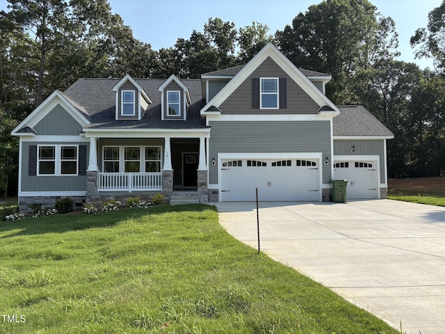 78 Mineral Springs Way, Benson, NC 27504 - craftsman-style house featuring concrete driveway, covered porch, a front lawn, a shingled roof, and a garage