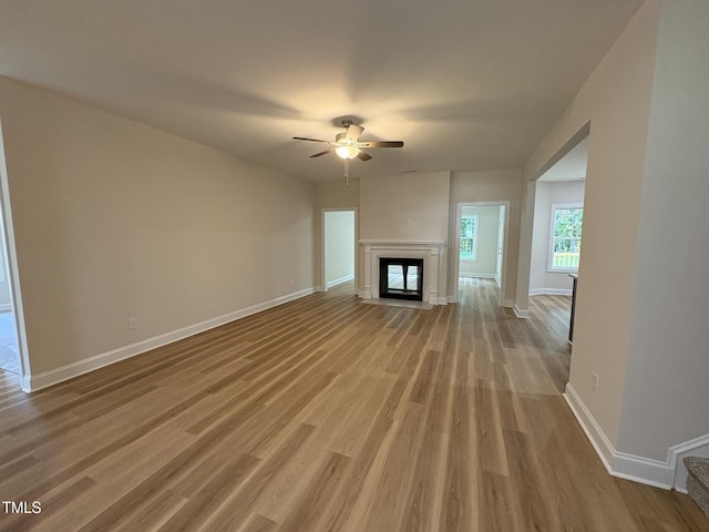 78 Mineral Springs Way, Benson, NC 27504 - unfurnished living room with ceiling fan, wood finished floors, and a glass covered fireplace