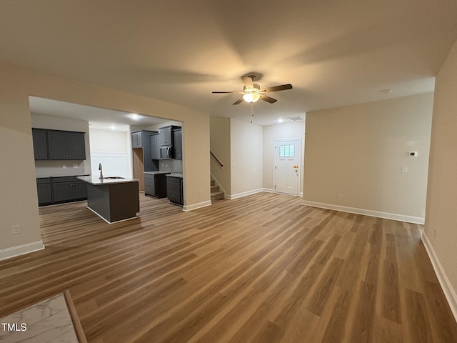 78 Mineral Springs Way, Benson, NC 27504 - unfurnished living room with wood finished floors, stairway, and ceiling fan