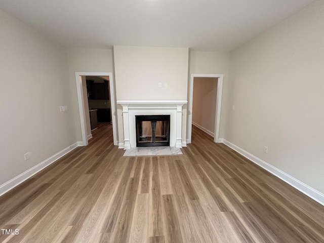 78 Mineral Springs Way, Benson, NC 27504 - unfurnished living room featuring a fireplace with flush hearth and wood finished floors