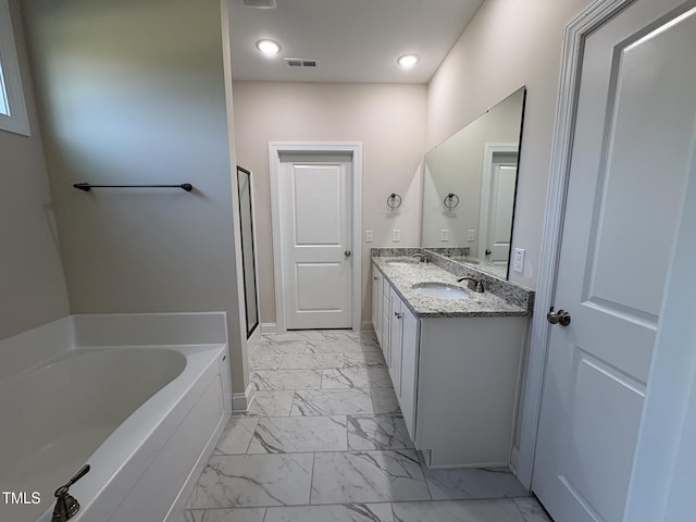 78 Mineral Springs Way, Benson, NC 27504 - full bath featuring marble look tile flooring, a garden tub, double vanity, a stall shower, and recessed lighting