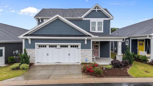 33 Davidson St, Clayton, NC 27527 - craftsman house with stone siding, covered porch, driveway, and central air condition unit