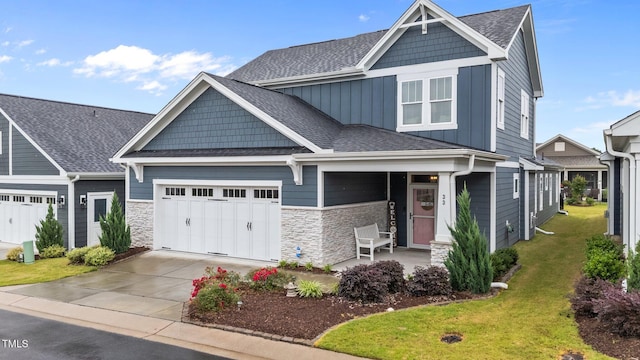 33 Davidson St, Clayton, NC 27527 - craftsman-style home with concrete driveway, an attached garage, stone siding, and a front lawn