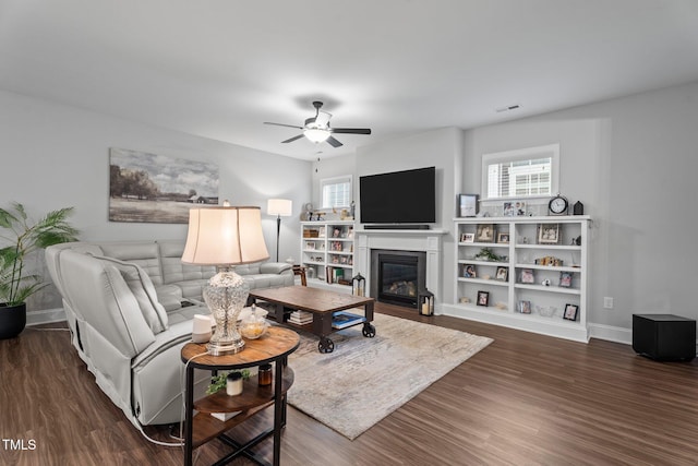 33 Davidson St, Clayton, NC 27527 - living area featuring a glass covered fireplace, a ceiling fan, dark wood-style floors, and baseboards
