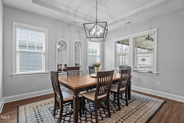 33 Davidson St, Clayton, NC 27527 - dining room with dark wood-style flooring, a tray ceiling, a chandelier, ornamental molding, and baseboards