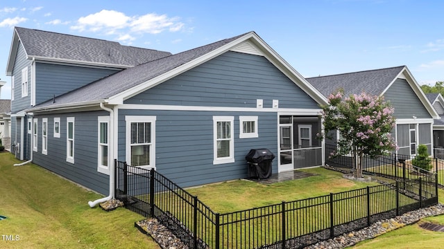 33 Davidson St, Clayton, NC 27527 - rear view of property with a shingled roof and a sunroom