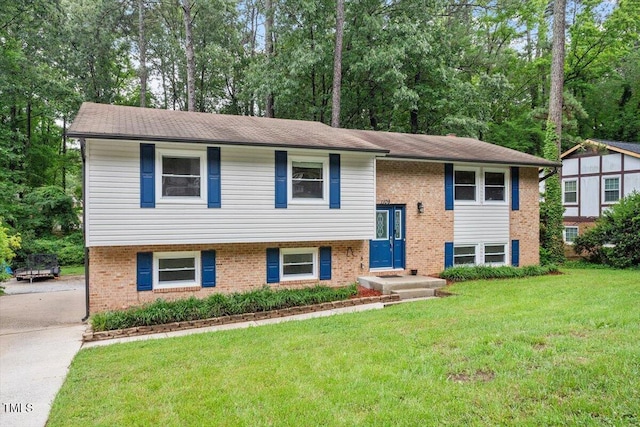1109 Buckingham Rd, Garner, NC 27529 - raised ranch with a front yard, brick siding, and view of scattered trees