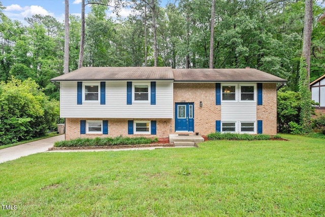 1109 Buckingham Rd, Garner, NC 27529 - split foyer home with a front yard, brick siding, and view of scattered trees