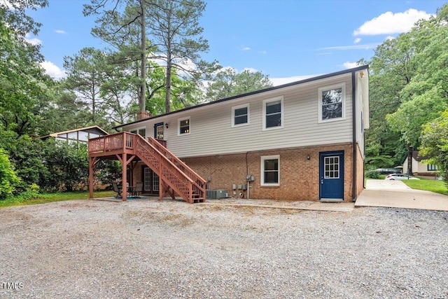 1109 Buckingham Rd, Garner, NC 27529 - rear view of property featuring stairs, central AC, a wooden deck, and brick siding