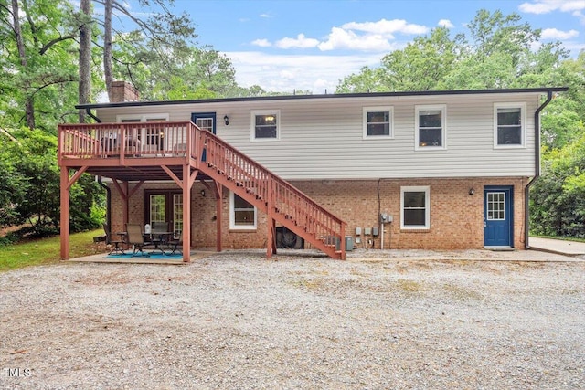 1109 Buckingham Rd, Garner, NC 27529 - back of house featuring a chimney, brick siding, a deck, and stairway