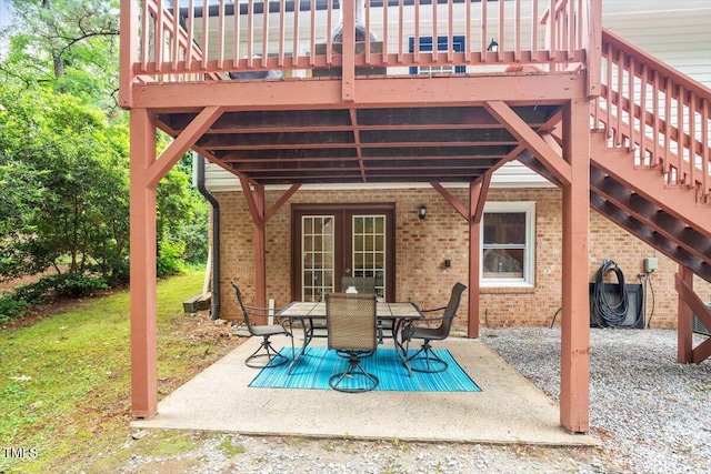 1109 Buckingham Rd, Garner, NC 27529 - view of patio with outdoor dining area, a wooden deck, and french doors