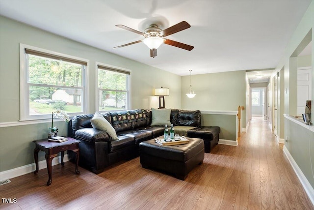 1109 Buckingham Rd, Garner, NC 27529 - living area featuring wood finished floors, plenty of natural light, a ceiling fan, and baseboards
