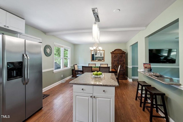 1109 Buckingham Rd, Garner, NC 27529 - kitchen with stainless steel refrigerator with ice dispenser, white cabinets, dark wood finished floors, a kitchen island, and beamed ceiling