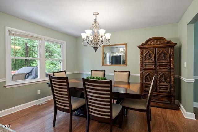 1109 Buckingham Rd, Garner, NC 27529 - dining room featuring a chandelier, wood finished floors, and baseboards