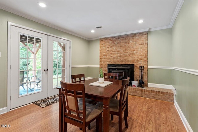 1109 Buckingham Rd, Garner, NC 27529 - dining room with french doors, wood finished floors, recessed lighting, baseboards, and crown molding
