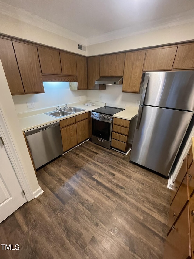 3522 Ivy Commons Dr Unit 101, Raleigh, NC 27606 - kitchen featuring appliances with stainless steel finishes, under cabinet range hood, a sink, dark wood-style floors, and light countertops