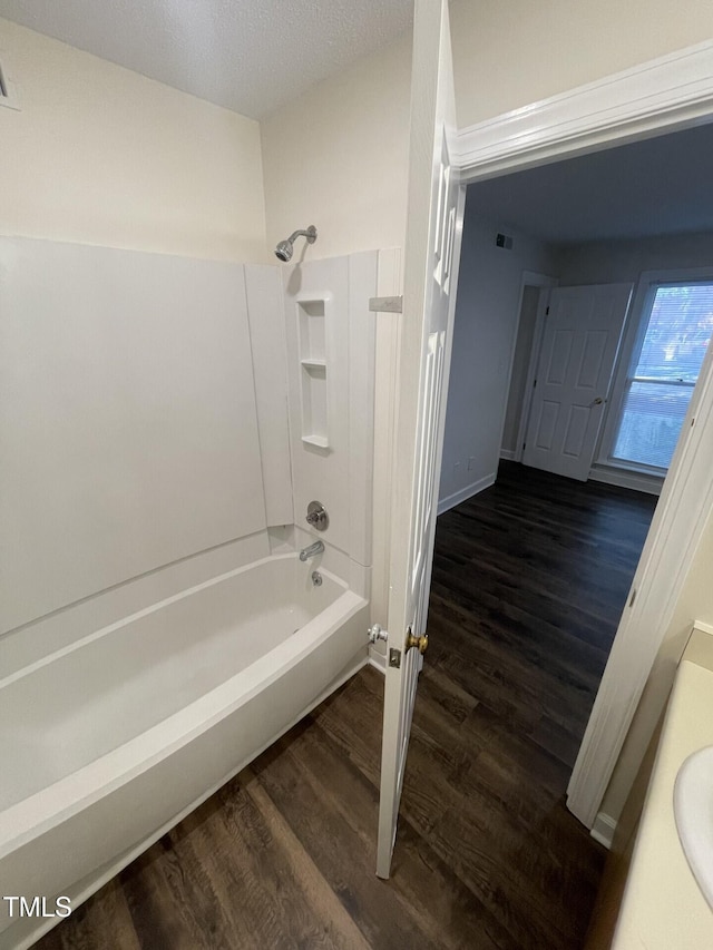 3522 Ivy Commons Dr Unit 101, Raleigh, NC 27606 - bathroom with wood finished floors, bathtub / shower combination, baseboards, and vanity